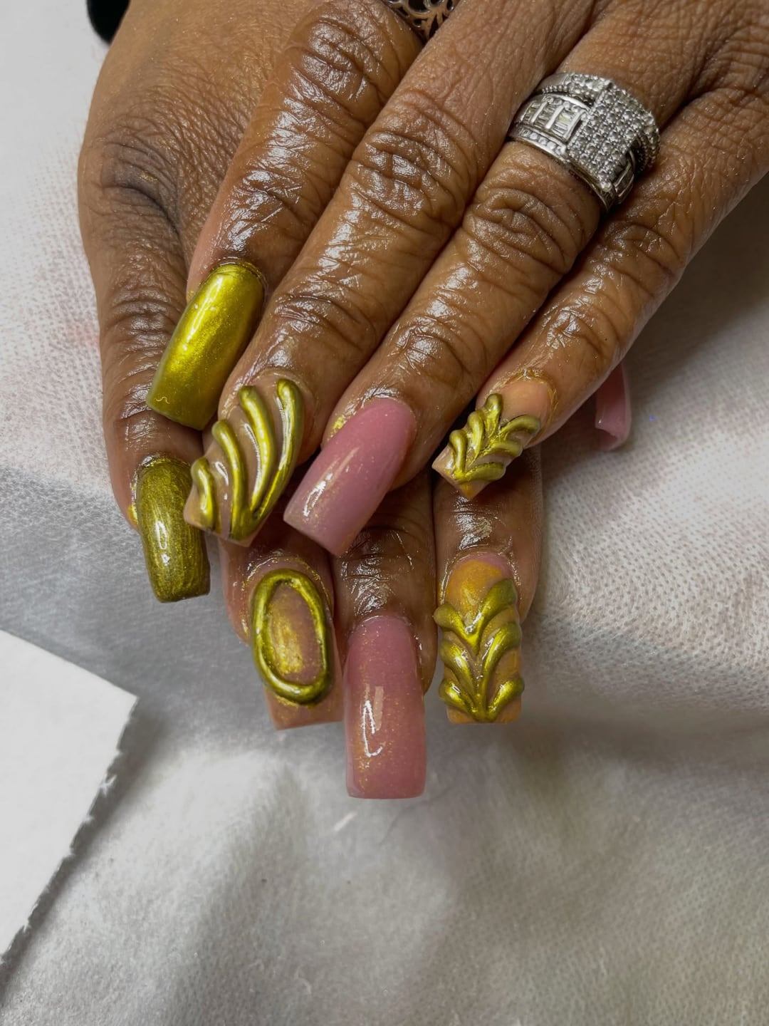 Gold chrome coffin nails with a bare accent