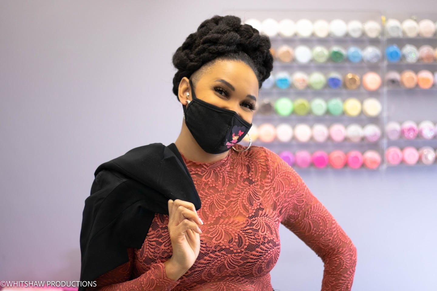 Yvette in the studio in front of her wall of gel colors